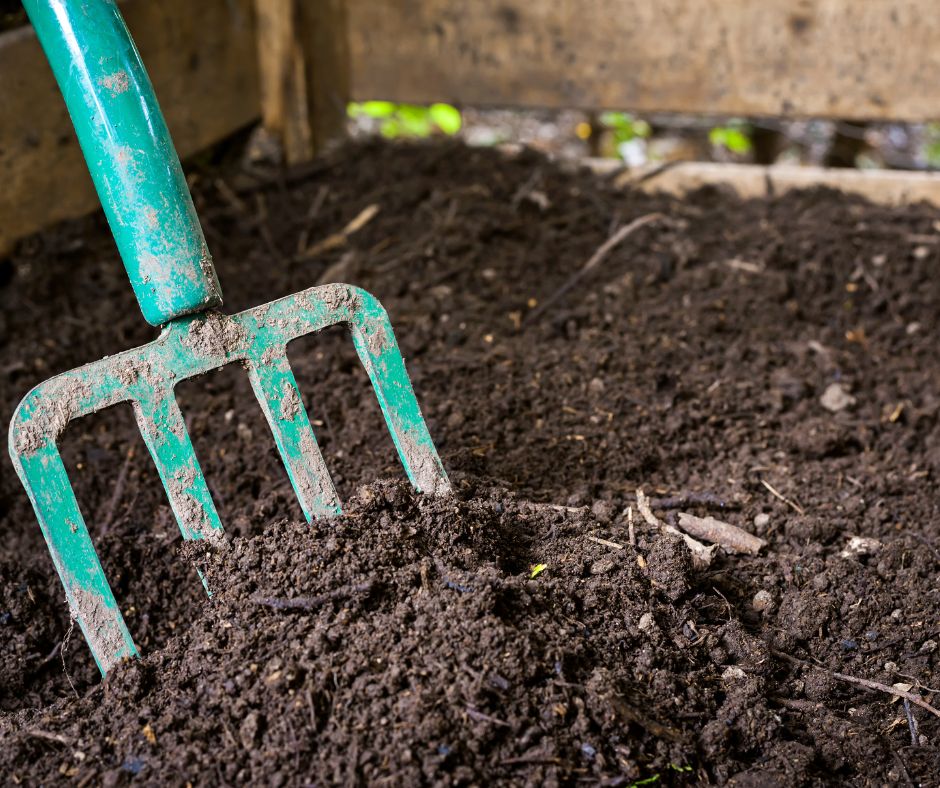 Tipping of compost with garden fork