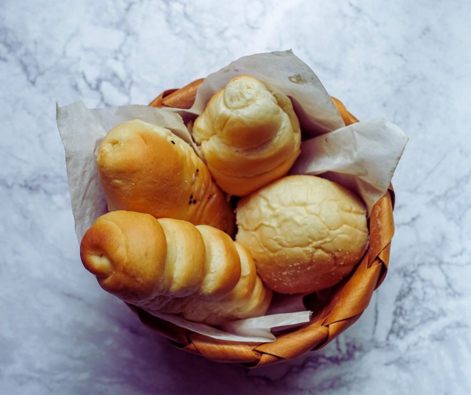 various types of bread in a wooden bowl