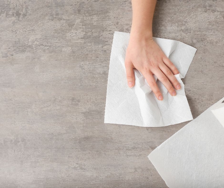 Cleaning kitchen surface with paper towel