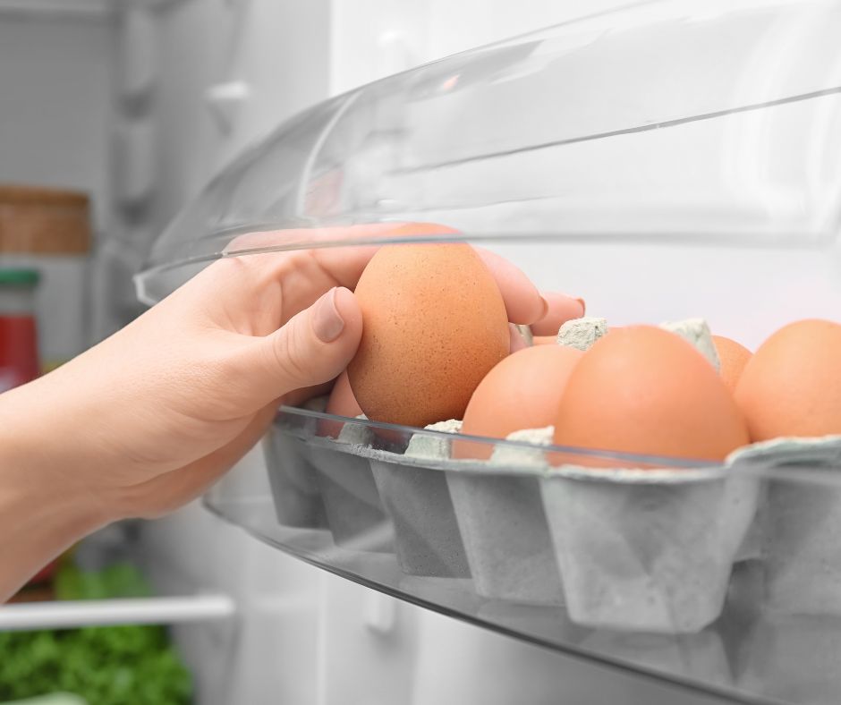 Reaching for eggs in fridge